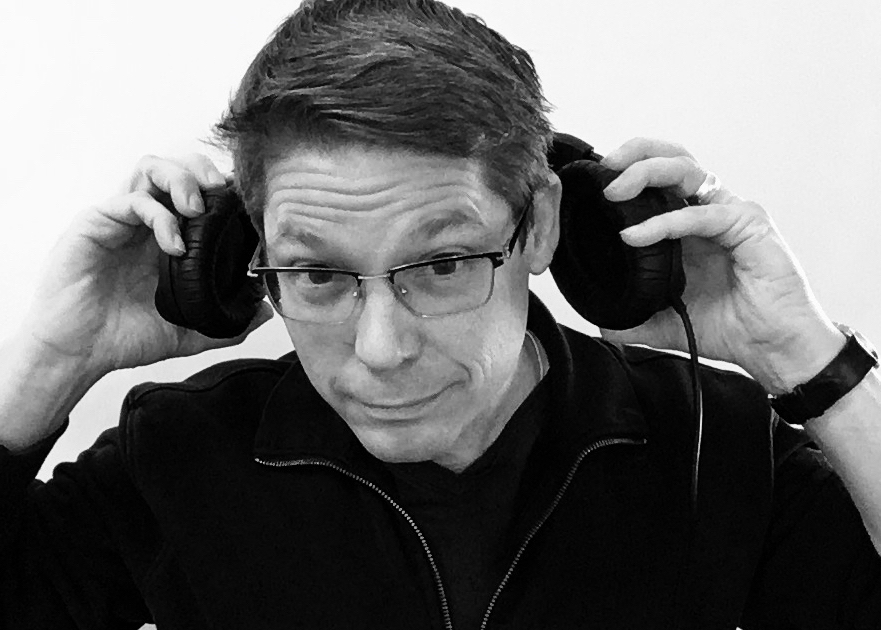 David Wetzel putting a pair of over hear headphones on. David Wetzel putting a pair of over hear headphones on.